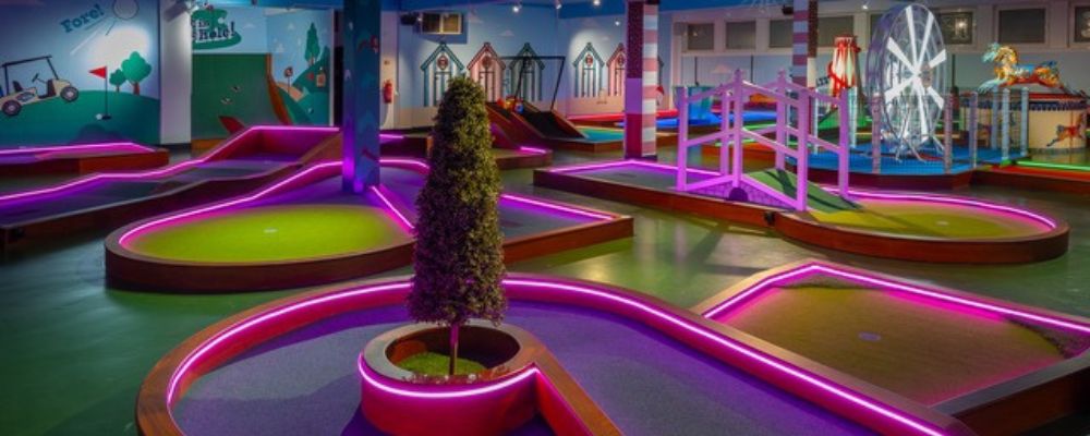 Neon LED strip lights lighting up Putt Hutt crazy golf course, Clarence Pier, Southsea